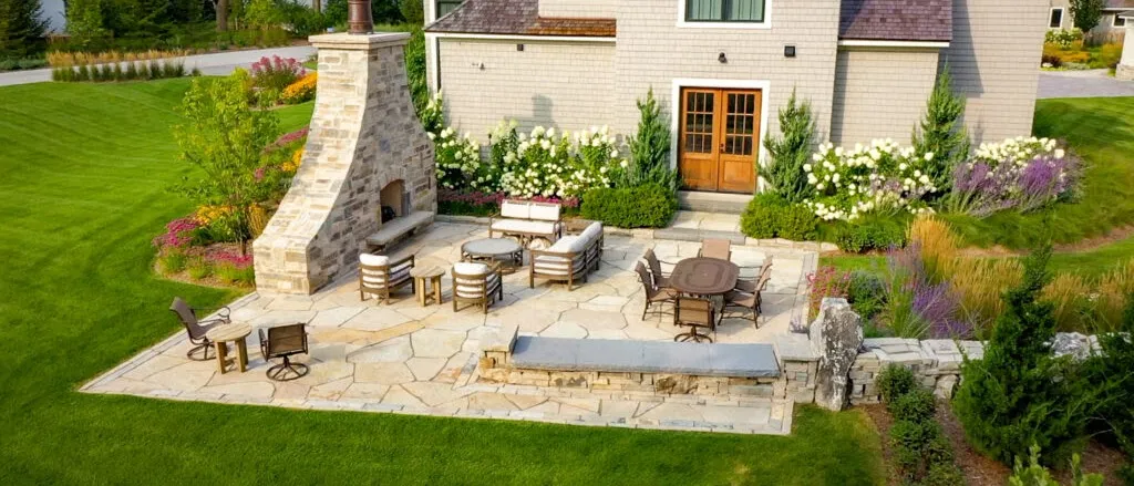 Stone patio with outdoor fireplace and seating area